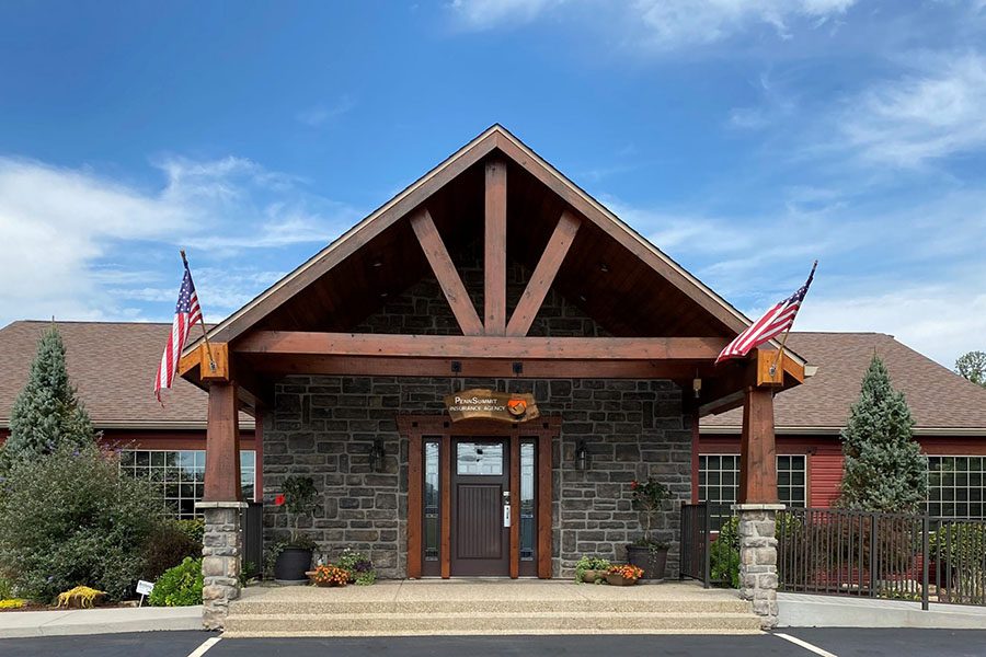 Homepage - Exterior View of the Penn Summit Insurance Agency Office Building in Chalk Hill Pennsylvania Against a Bright Blue Sky